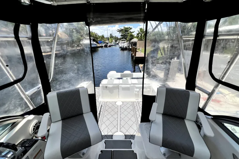 Slide: The Image of Interior view of a 2004 Century 3200 Walk-Around boat with two seats and clear canopy. - 60