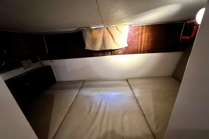 Slide: The Image of Interior cabin of 2004 Century 3200 Walk-Around boat, featuring a cozy sleeping area. - 100