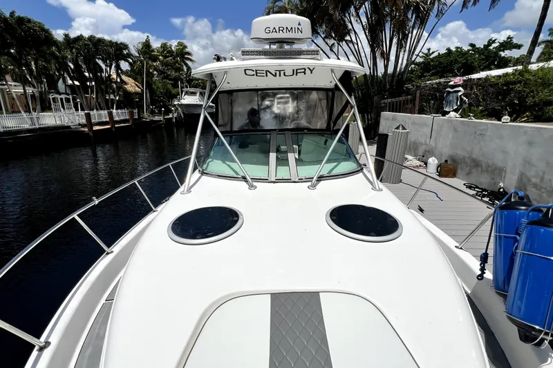 Slide: The Image of 2004 Century 3200 Walk-Around boat docked, featuring Garmin equipment and sleek design. - 40