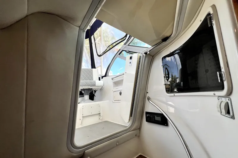 Slide: The Image of Interior view of a 2004 Century 3200 Walk-Around boat, showcasing seating and cabin details. - 62