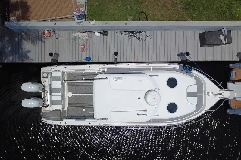 Slide: The Image of Overhead view of a 2004 Century 3200 Walk-Around boat docked at a pier. - 8