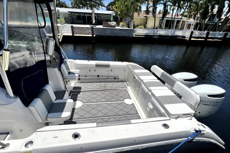 Slide: The Image of 2004 Century 3200 Walk-Around boat with spacious seating and dual Suzuki engines. - 27