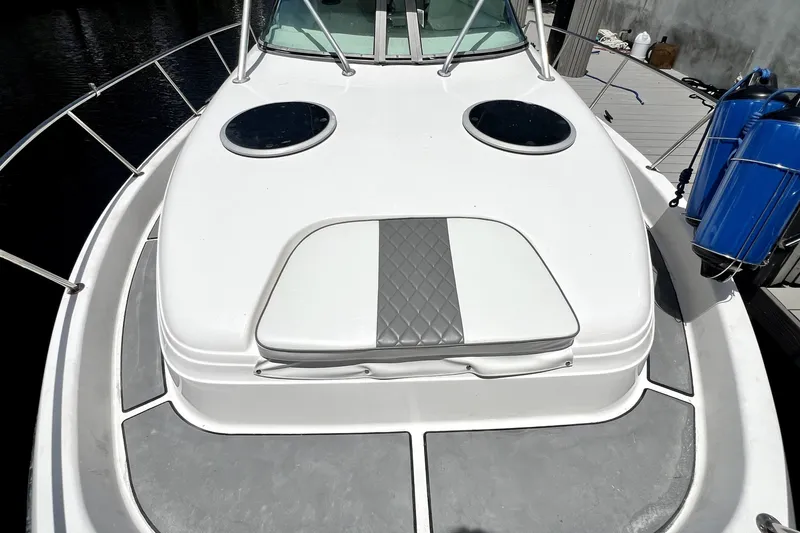 Slide: The Image of 2004 Century 3200 Walk-Around boat deck with dual hatches and cushioned seating. - 41