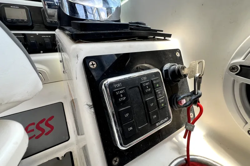 Slide: The Image of Control panel of a 2004 Century 3200 Walk-Around boat with Suzuki engine controls. - 96