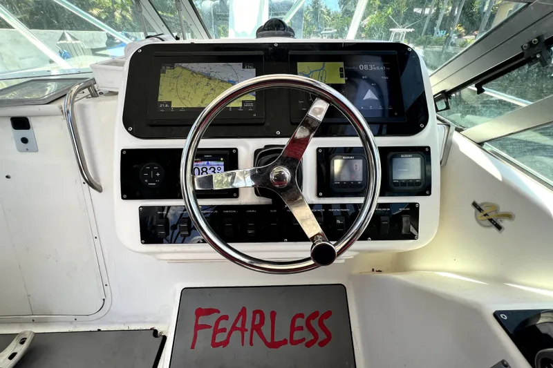 Slide: The Image of 2004 Century 3200 Walk-Around boat dashboard with navigation screens and "Fearless" text. - 97