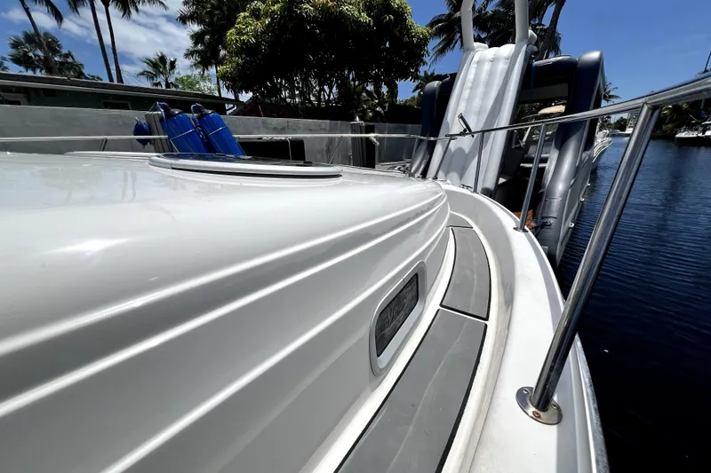 Slide: The Image of 2004 Century 3200 Walk-Around boat docked, featuring sleek design and stainless steel railings. - 69