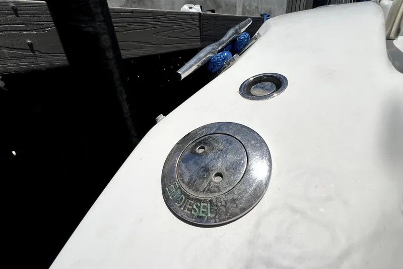 Slide: The Image of Fuel cap on 2004 Century 3200 Walk-Around boat, labeled "DIESEL," with cleat and rope nearby. - 75