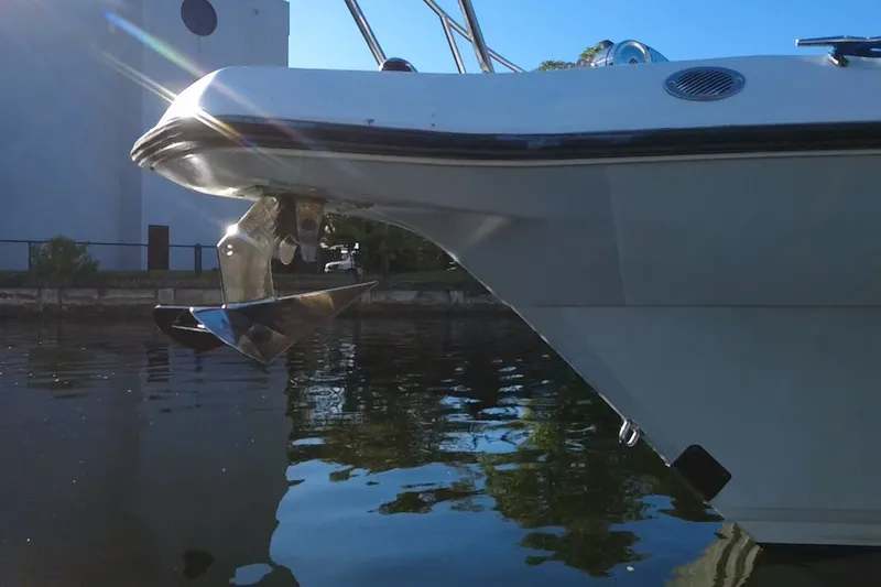 Slide: The Image of 2004 Century 3200 Walk-Around boat with anchor, reflecting on calm water. - 11