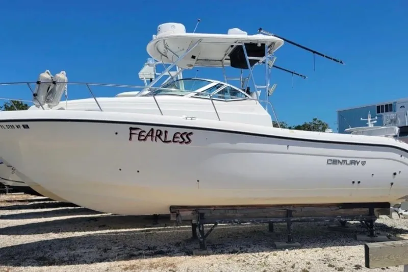 Slide: The Image of 2004 Century 3200 Walk-Around boat named "Fearless" on display under clear blue sky. - 10
