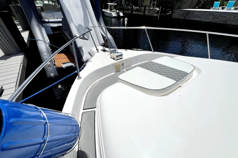 Slide: The Image of 2004 Century 3200 Walk-Around boat docked, featuring a sleek deck and hatch. - 35