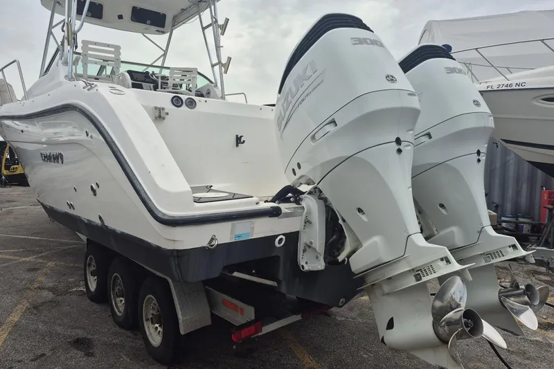Slide: The Image of 2004 Century 3200 Walk-Around boat with dual Suzuki outboard motors on a trailer. - 5