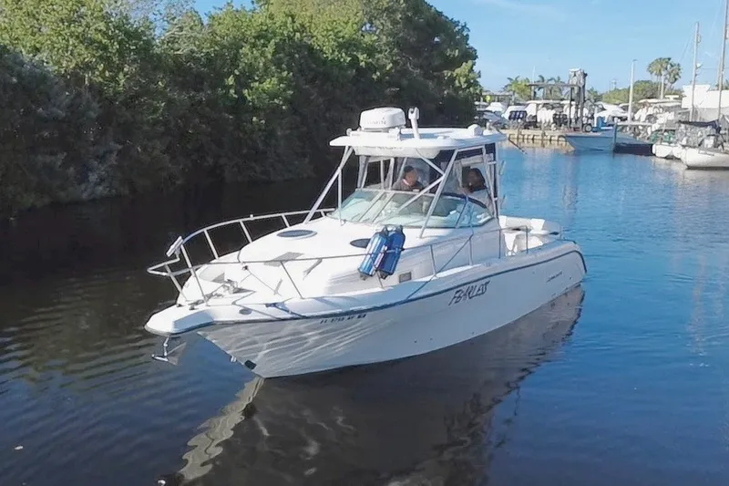 The Image of 2004 Century 3200 Walk-Around boat cruising on a calm waterway. - 0