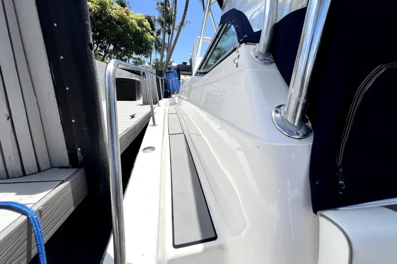 Slide: The Image of 2004 Century 3200 Walk-Around boat docked, showcasing sleek design and sturdy railing. - 33