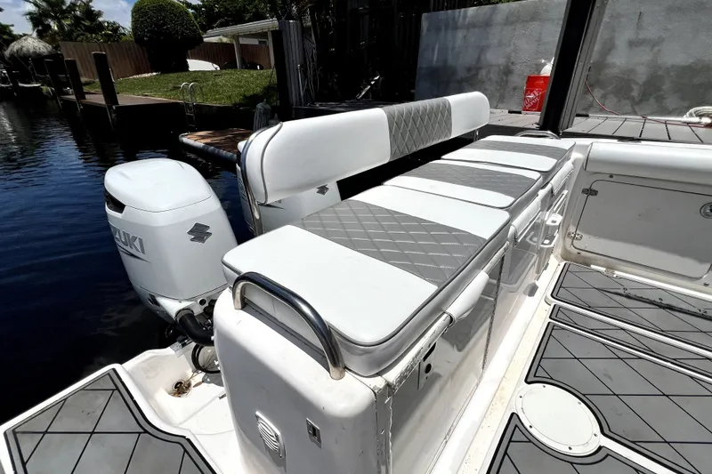 Slide: The Image of 2004 Century 3200 Walk-Around boat with Suzuki outboard motor and cushioned seating. - 57