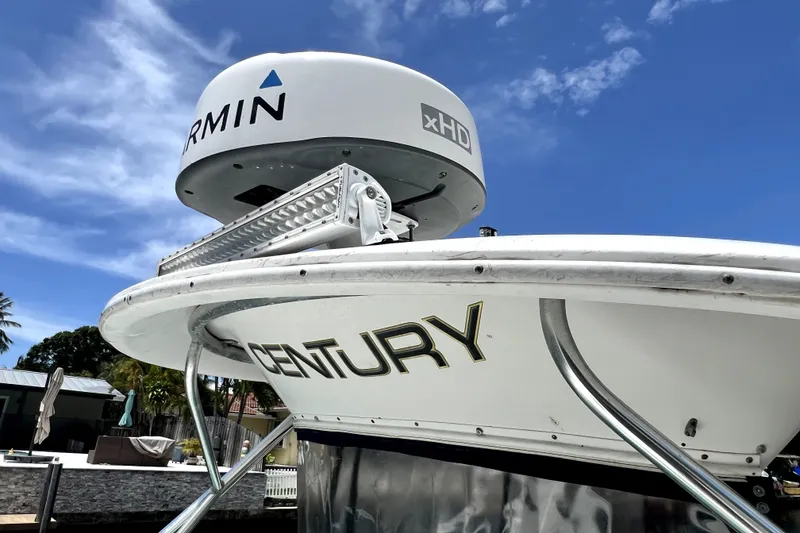 Slide: The Image of 2004 Century 3200 Walk-Around boat with Garmin xHD radar under clear blue sky. - 38