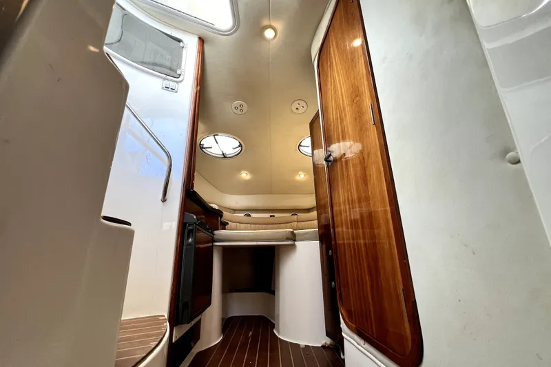 Slide: The Image of 2004 Century 3200 Walk-Around cabin interior with wood accents and seating area. - 112