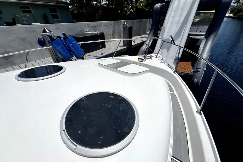 Slide: The Image of 2004 Century 3200 Walk-Around boat deck with hatches and docked equipment. - 45