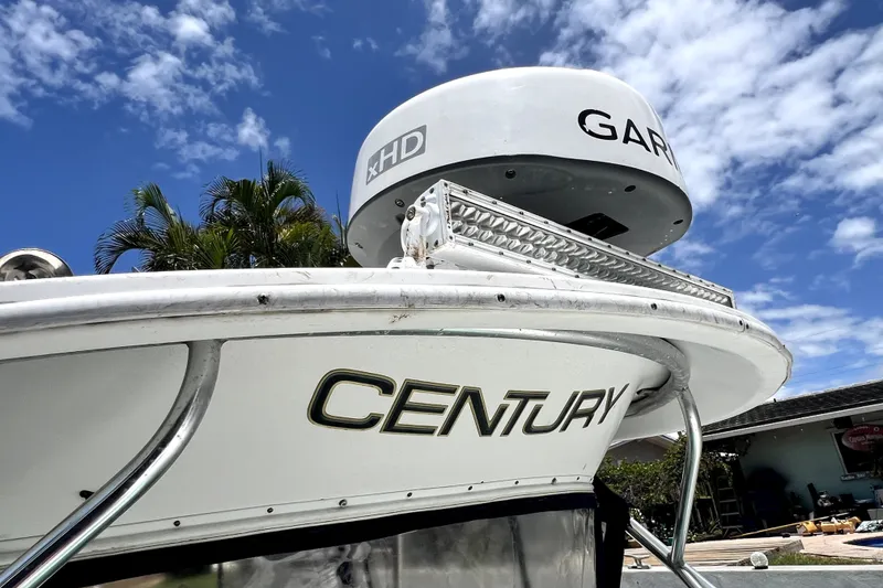 Slide: The Image of 2004 Century 3200 Walk-Around boat with Garmin radar, under a clear blue sky. - 48