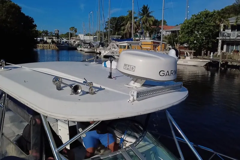 Slide: The Image of 2004 Century 3200 Walk-Around boat with Garmin radar, docked in a marina. - 12