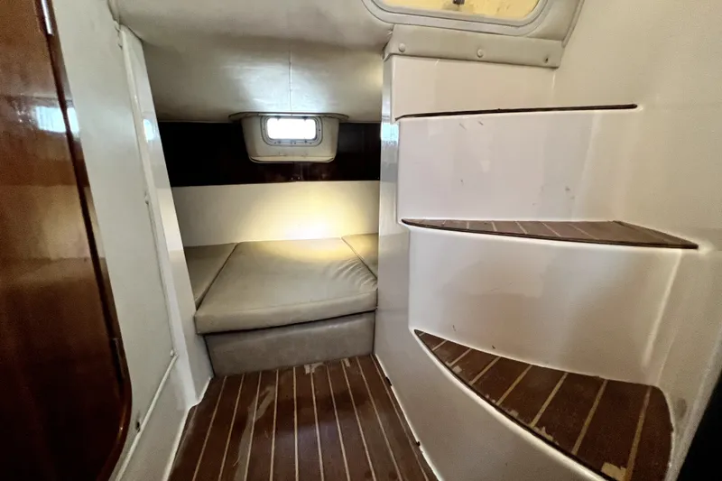 Slide: The Image of Interior cabin of 2004 Century 3200 Walk-Around boat with wooden flooring and seating. - 103