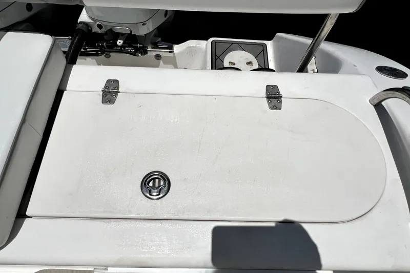 Slide: The Image of 2004 Century 3200 Walk-Around boat deck with storage hatch and metal hinges. - 85