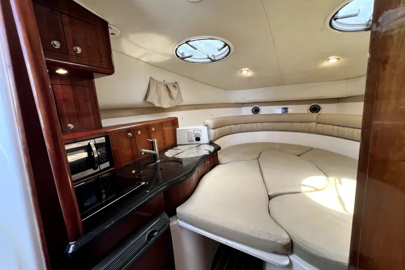 Slide: The Image of 2004 Century 3200 Walk-Around cabin interior with kitchenette and seating area. - 110