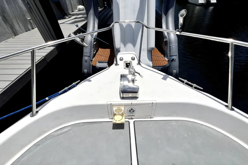 Slide: The Image of Bow view of a 2004 Century 3200 Walk-Around boat docked at a marina. - 54