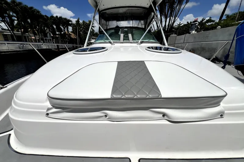Slide: The Image of 2004 Century 3200 Walk-Around boat with sleek white deck and cushioned seating. - 42