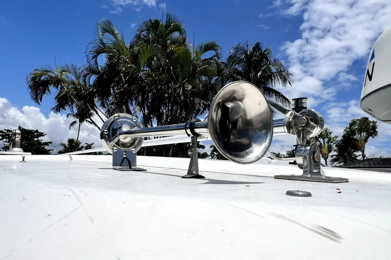 Slide: The Image of Chrome boat horn on 2004 Century 3200 Walk-Around, with palm trees and blue sky background. - 47