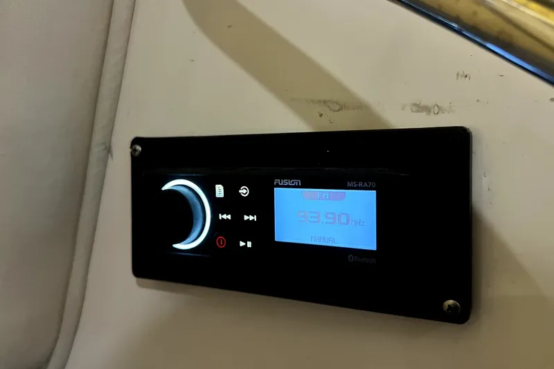 Slide: The Image of Fusion MS-RA70 stereo system on 2004 Century 3200 Walk-Around boat, displaying FM 93.90 MHz. - 104