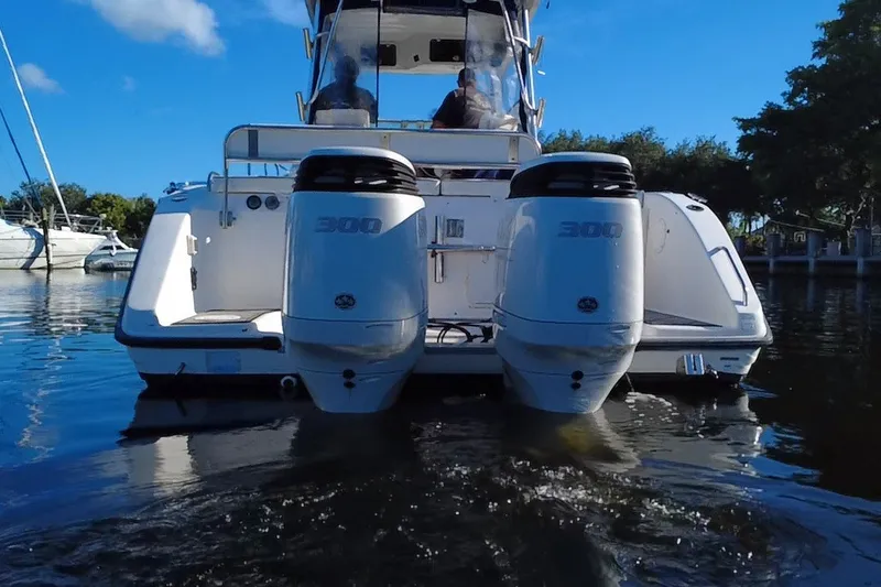 Slide: The Image of 2004 Century 3200 Walk-Around boat with dual 300 horsepower engines on calm water. - 4