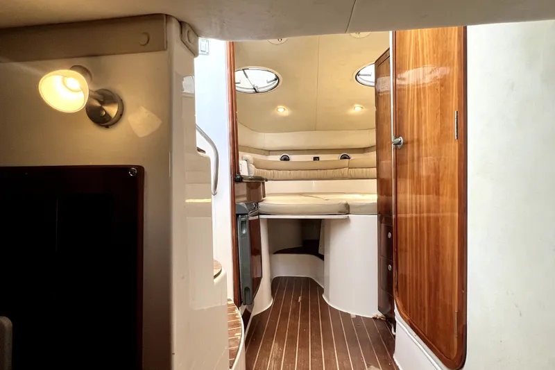 Slide: The Image of Interior of 2004 Century 3200 Walk-Around boat with cozy cabin and wooden finishes. - 114
