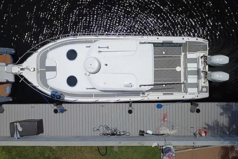 Slide: The Image of Overhead view of a 2004 Century 3200 Walk-Around boat docked at a pier. - 15