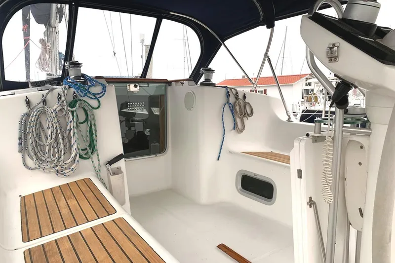 Slide: The Image of Cockpit of 2000 Jeanneau Sun Odyssey 37 sailboat with ropes and wooden seating. - 10