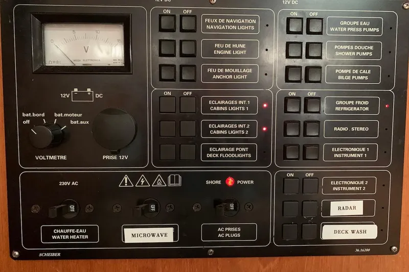 Slide: The Image of Electrical control panel of a 2000 Jeanneau Sun Odyssey 37 sailboat, featuring switches and voltmeter. - 40