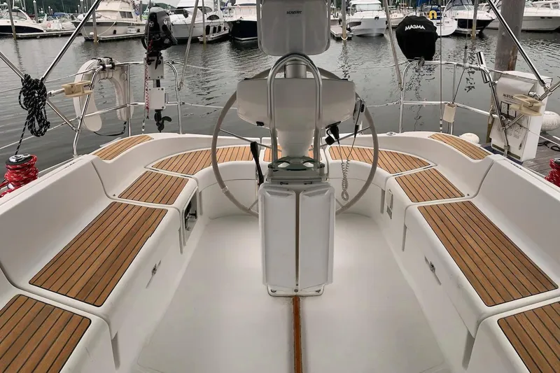 Slide: The Image of Cockpit of 2000 Jeanneau Sun Odyssey 37 sailboat with teak seating and steering wheel. - 11