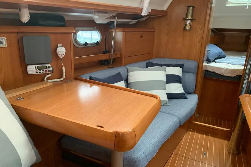 Slide: The Image of Interior of 2000 Jeanneau Sun Odyssey 37 sailboat with cozy seating and wooden finishes. - 33