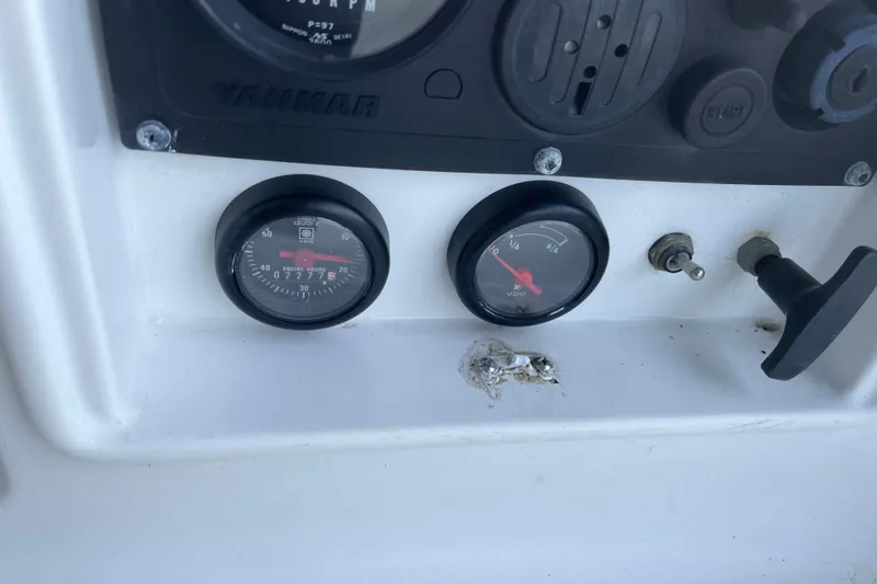 Slide: The Image of Control panel of a 2000 Jeanneau Sun Odyssey 36.2 sailboat with gauges and switches. - 13