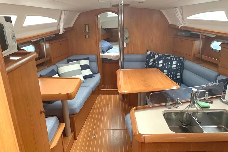 Slide: The Image of Interior of 2000 Jeanneau Sun Odyssey 37 sailboat with cozy seating and wooden finishes. - 25