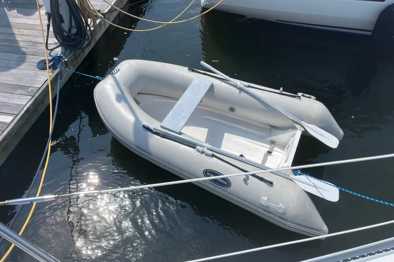 Slide: The Image of Inflatable dinghy tied to dock near Jeanneau Sun Odyssey 36.2, 2000 model. - 46