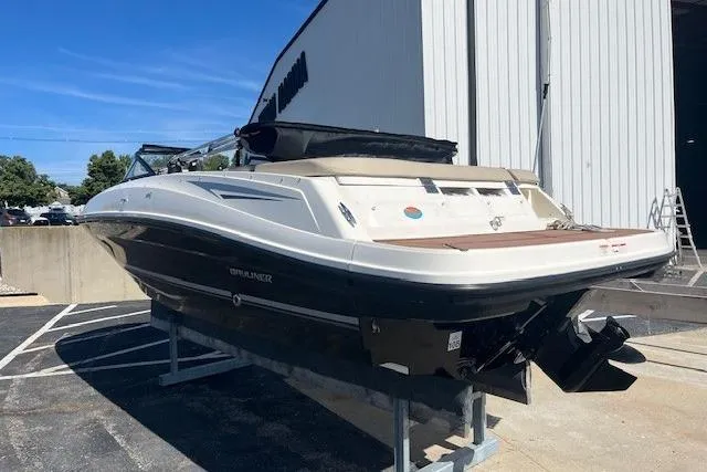 Slide: The Image of 2016 Bayliner VR5 Bowrider I/O boat on display outside a building. - 2