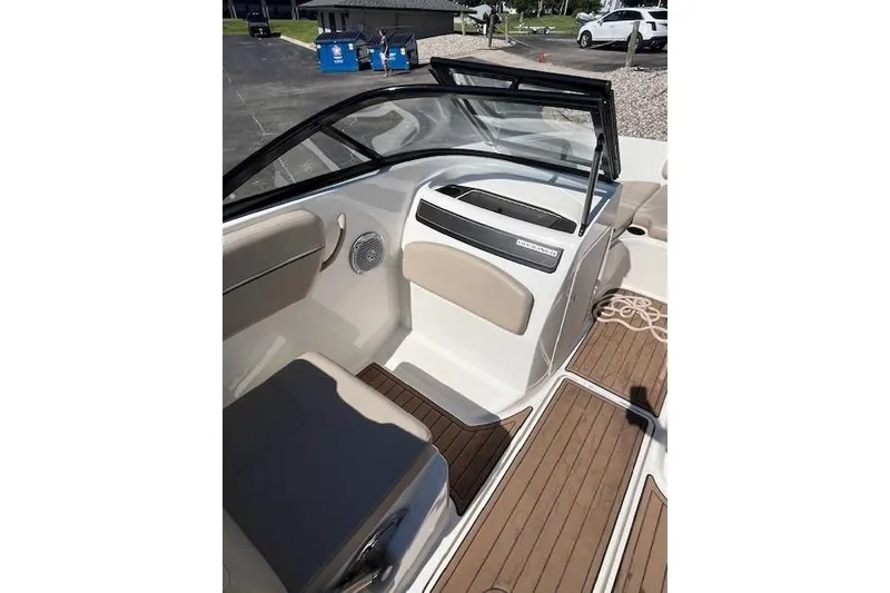 Slide: The Image of 2016 Bayliner VR5 Bowrider I/O interior with beige seating and wood-style flooring. - 16