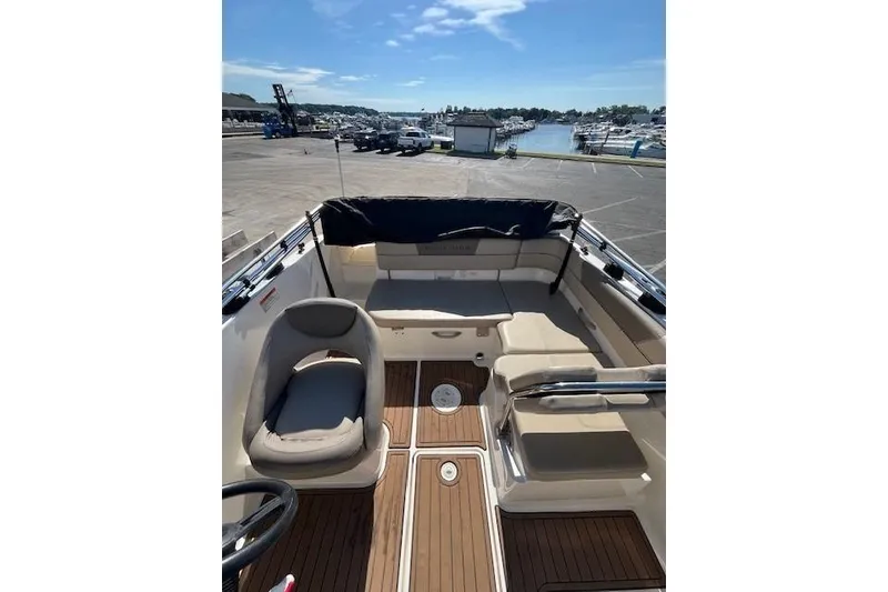 Slide: The Image of 2016 Bayliner VR5 Bowrider I/O interior with seating and wood flooring at marina. - 6
