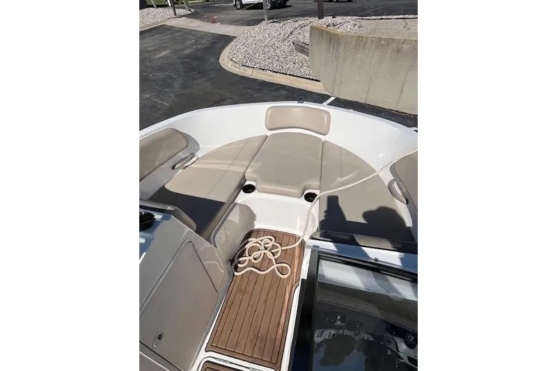 Slide: The Image of 2016 Bayliner VR5 Bowrider I/O boat interior with beige seating and wooden flooring. - 15