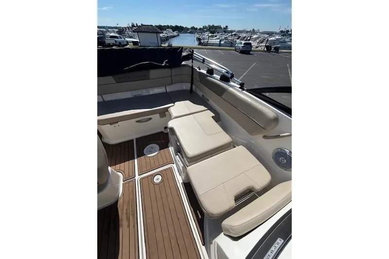 Slide: The Image of 2016 Bayliner VR5 Bowrider I/O interior with beige seating and wood flooring at marina. - 19