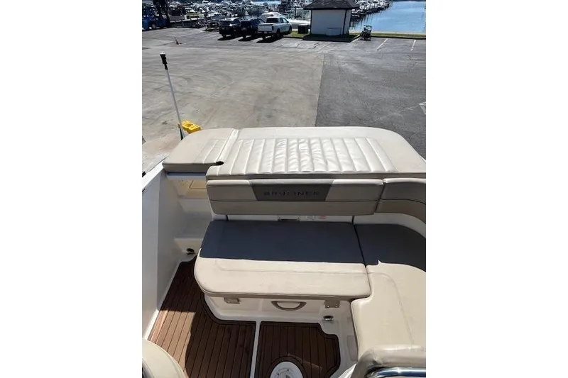 Slide: The Image of 2016 Bayliner VR5 Bowrider I/O boat interior with beige seating and wooden flooring. - 4
