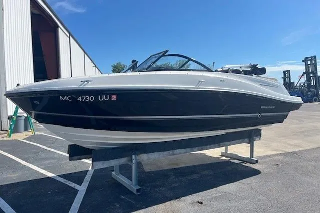 Slide: The Image of 2016 Bayliner VR5 Bowrider I/O boat on display at a marina. - 1