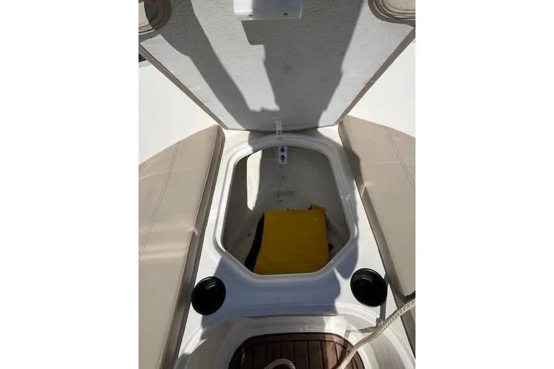 Slide: The Image of 2016 Bayliner VR5 Bowrider I/O storage compartment with open hatch and visible yellow item. - 14