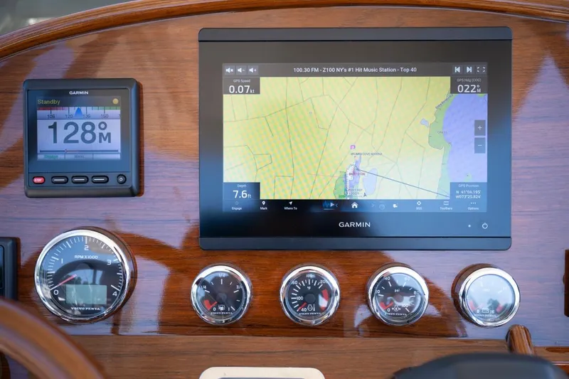 Slide: The Image of Hinckley Talaria 29C 2021 dashboard with Garmin navigation and instrument gauges. - 10