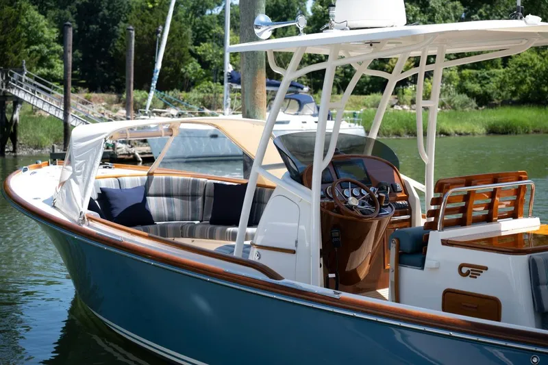 Slide: The Image of 2021 Hinckley Talaria 29C boat with elegant interior and polished wood accents. - 4